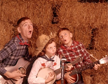 silly - 1950s - 1960s TWO BROTHERS AND A SISTER PLAYING INSTRUMENTS GUITARS AND BANJO SINGING COUNTRY MUSIC Stock Photo - Rights-Managed, Code: 846-05647251