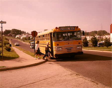 simsearch:846-05647208,k - 1960s BOY GIRL SUBURBAN COMMUNITY STREET GETTING INTO SCHOOL BUS Stock Photo - Rights-Managed, Code: 846-05647434