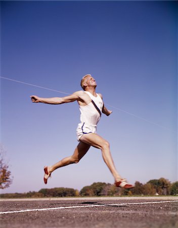 pic of run through finish - 1960s RUNNER AT FINISH LINE BREAKING THROUGH TAPE Stock Photo - Rights-Managed, Code: 846-05647441