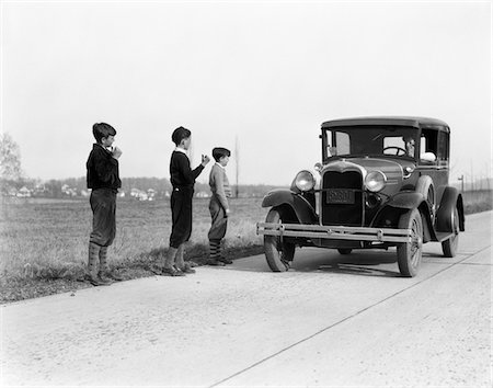 1930s - 1920s MAN DRIVING FORD MODEL A CAR 3 BOYS HITCHHIKING Foto de stock - Con derechos protegidos, Código: 846-05647645