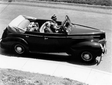 simsearch:846-06111843,k - 1930s - 1940s COUPLE HUSBAND AND WIFE DRIVING 1938 CONVERTIBLE FOUR DOOR SEDAN AUTOMOBILE WITH LUGGAGE IN BACK SEAT Stock Photo - Rights-Managed, Code: 846-05647680