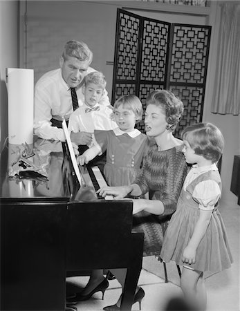 simsearch:846-02794249,k - 1960s FAMILY STANDING AROUND PIANO SINGING Stock Photo - Rights-Managed, Code: 846-05647683