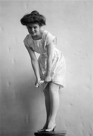 simsearch:846-05646401,k - 1900s - 1910s SMILING WOMAN WITH GIBSON GIRL HAIR STYLE RINGING OUT WET CHEMISE HEMLINE Stock Photo - Rights-Managed, Code: 846-05647765