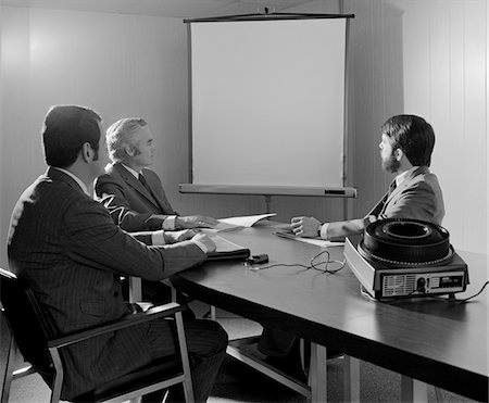 simsearch:846-05647277,k - 1970s THREE EXECUTIVE BUSINESSMEN CONFERENCE TABLE AUDIOVISUAL PRESENTATION Stock Photo - Rights-Managed, Code: 846-05647773