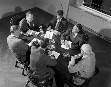 simsearch:846-05647782,k - 1950s - 1960s SIX BUSINESSMEN EXECUTIVES MANAGERS SALESMEN MEETING AROUND CORPORATE CONFERENCE TABLE Stock Photo - Rights-Managed, Code: 846-05647796