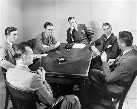 smoking men 1930s - 1930s - 1940s 6 BUSINESSMEN MEETING IN BOARDROOM AROUND TABLE WITH ASHTRAYS Stock Photo - Rights-Managed, Code: 846-05647797