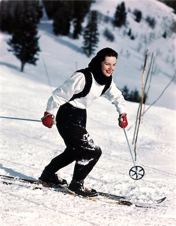 sports fashion - 1940s - 1950s SMILING WOMAN SKIING WEARING BLUE AND WHITE SKI OUTFIT WITH RED GLOVES Stock Photo - Rights-Managed, Code: 846-05647822