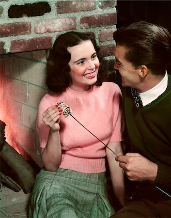 retro teenagers - 1950s SMILING TEEN COUPLE TOASTING MARSHMALLOWS IN FIREPLACE Stock Photo - Rights-Managed, Code: 846-05647836