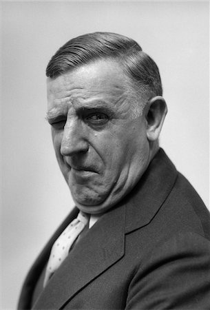 1930s - 1940s PORTRAIT OF GRUFF OLDER MAN BUSINESSMAN SALESMAN CHARACTER WINKING Stock Photo - Rights-Managed, Code: 846-05647915