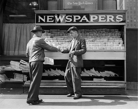 simsearch:846-03163141,k - 1940s MAN BUYING NEWSPAPER FROM VENDOR ON SIDEWALK NEW YORK CITY Stock Photo - Rights-Managed, Code: 846-05648003