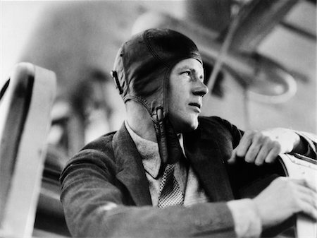 simsearch:846-06112007,k - 1920s CLOSE-UP OF CHARLES LINDBERG IN LEATHER AVIATOR CAP SITTING IN COCKPIT OF PLANE Stock Photo - Rights-Managed, Code: 846-05648037