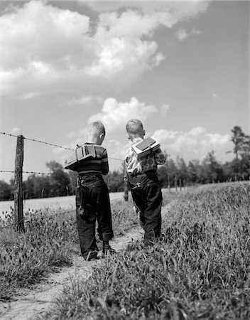 1950s BACK VIEW 2 BOYS WITH BOOK PACKS WALKING TO FROM SCHOOL Stock Photo - Rights-Managed, Code: 846-05648105