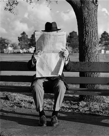 1960s HUMOR PORTRAIT MAN WEARING HAT SITTING ON PARK BENCH READING NEWSPAPER Stock Photo - Rights-Managed, Code: 846-05648127