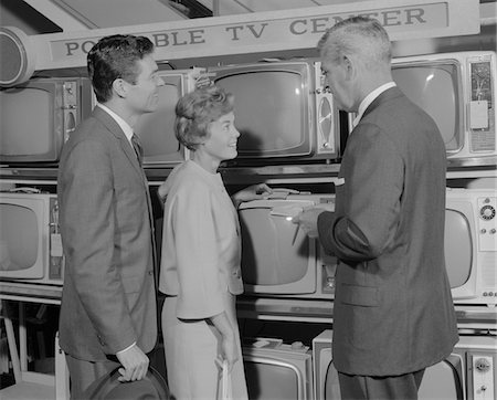 simsearch:846-02796796,k - 1960s COUPLE SHOPPING FOR PORTABLE TV BEING HELPED BY SALESMAN Stock Photo - Rights-Managed, Code: 846-05648140