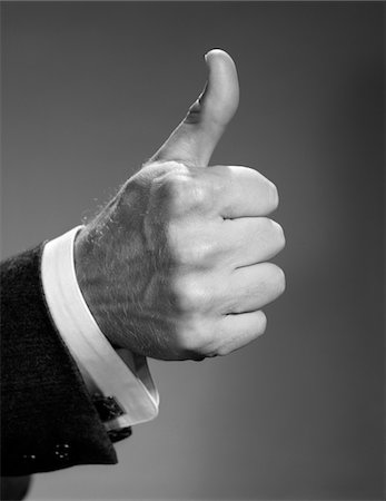 1960s CLOSE-UP OF HAND MAKING THUMBS-UP EXPRESSION SYMBOLIC OF SUCCESS AND WINNING BUSINESSMAN STUDIO Stock Photo - Rights-Managed, Code: 846-05648184