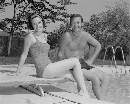 swimming pool people b&w - 1960s MAN WOMAN COUPLE SITTING ON DIVING BOARD ON SIDE OF SWIMMING POOL Stock Photo - Rights-Managed, Code: 846-05648202