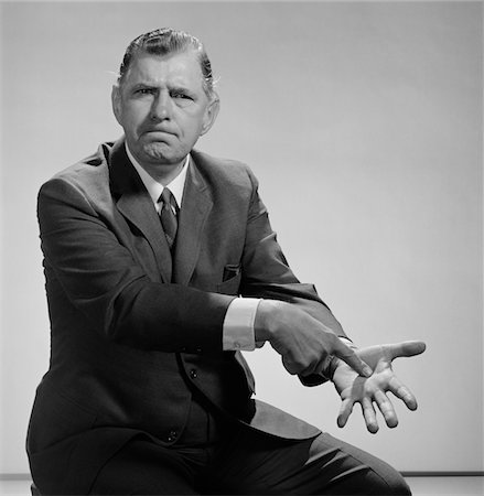 pointing someone rude - 1960s ANGRY MAN POINTING TO PALM OF HIS HAND Stock Photo - Rights-Managed, Code: 846-05648246