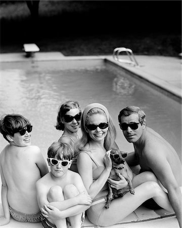 1960s - 1970s FAMILY PORTRAIT FATHER MOTHER SONS DAUGHTER SWIMMING POOL SIDE WITH DACHSHUND DOG ALL WEARING SUNGLASSES Stock Photo - Rights-Managed, Code: 846-05648302