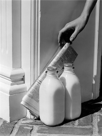 food delivery women - 1950s WOMAN'S HAND REACHING DOWN FOR NEWSPAPER PROPPED AGAINST 2 BOTTLES OF MILK AT DOORSTEP Stock Photo - Rights-Managed, Code: 846-05648355