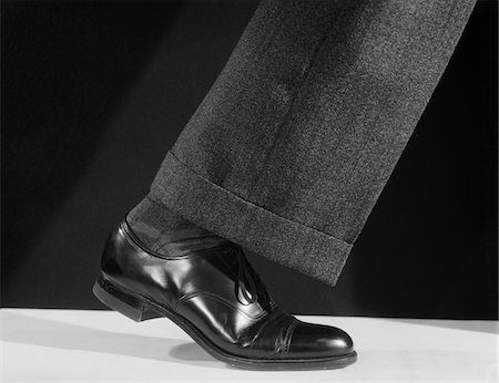 feet walking indoors - 1930s - 1940s - 1950s WALKING MAN'S SINGLE LEG LEATHER SHOE AND PANT CUFF Stock Photo - Rights-Managed, Code: 846-05648390