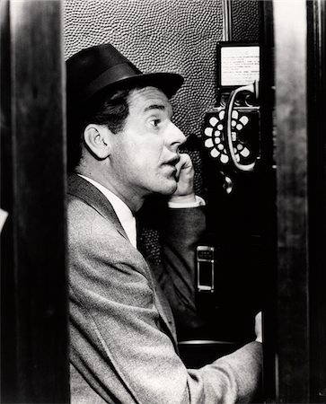 1930s BUSINESSMAN TALKING ON PUBLIC PAY TELEPHONE IN PHONE BOOTH Stock Photo - Rights-Managed, Code: 846-05648433