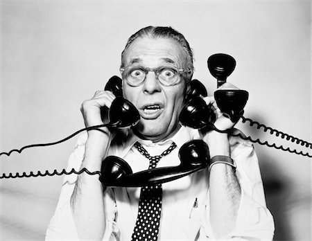 picture of person talking on string telephone - 1950s - 1960s PORTRAIT OF FRAZZLED BUSINESSMAN TRYING TO ANSWER FOUR BLACK TELEPHONES PHONES AT ONCE Stock Photo - Rights-Managed, Code: 846-05648445