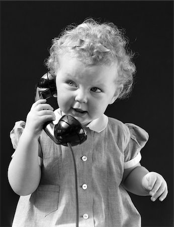 1940s CURLY HAIRED GIRL TODDLER TALKING ON TELEPHONE Stock Photo - Rights-Managed, Code: 846-05648498