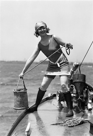 simsearch:846-05645985,k - 1920s WOMAN IN BATHING SUIT PULLING BUCKET OF WATER ABOARD A BOAT OUTDOOR Stock Photo - Rights-Managed, Code: 846-05648561