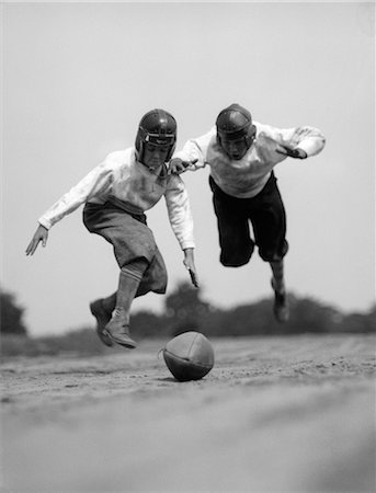 simsearch:846-06111843,k - 1930s PAIR OF BOYS IN KNICKERS & LEATHER HELMETS RACING TO DIVE ON FOOTBALL Stock Photo - Rights-Managed, Code: 846-06111798