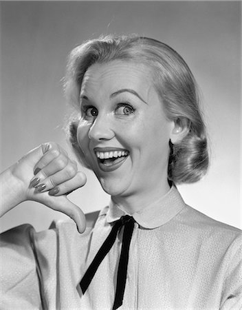 simsearch:846-05648370,k - 1950s WIDE-EYED SMILING BLOND PORTRAIT WOMAN POINTING TO HERSELF WITH THUMB, LOOKING AT CAMERA Stock Photo - Rights-Managed, Code: 846-06111827