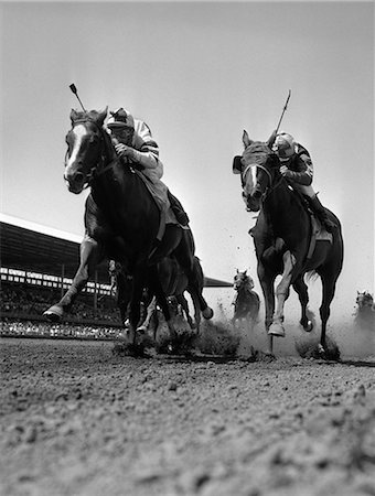 simsearch:862-03354658,k - 1960s WORM'S-EYE VIEW OF HORSE RACE WITH 2 LEADERS GALLOPING TOWARD CAMERA Stock Photo - Rights-Managed, Code: 846-06111881