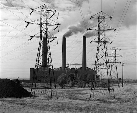 simsearch:846-02797081,k - 1950ER JAHRE INDUSTRIELLE KRAFTWERK BLAEULICH RAUCH ERZEUGEN STROM POWER LINE TOWERS IM VORDERGRUND Stockbilder - Lizenzpflichtiges, Bildnummer: 846-06111902