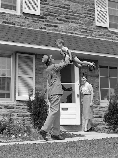 1950s 1960s FATHER COMING HOME LIFTING SON IN AIR WHILE WIFE LOOKS ON FROM DOORWAY Stock Photo - Premium Rights-Managed, Artist: ClassicStock, Image code: 846-06111954