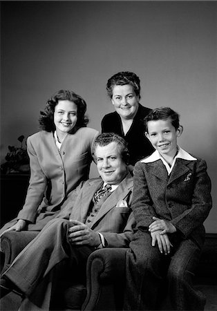 simsearch:846-02797855,k - 1940s PORTRAIT FAMILY MOTHER FATHER DAUGHTER SON SITTING TOGETHER ON CHAIR STUDIO Stock Photo - Rights-Managed, Code: 846-06111952