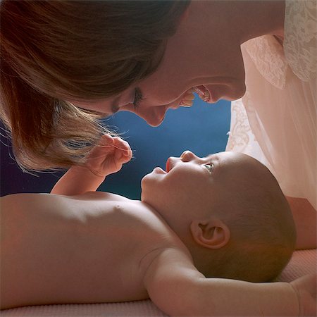 1960s MOTHER LOOKING DOWN ON BABY GIRL LYING ON BACK Stock Photo - Rights-Managed, Code: 846-06112028
