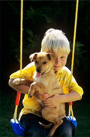 simsearch:846-06111765,k - BOY SITTING ON SWING WITH PUPPY Fotografie stock - Rights-Managed, Codice: 846-06112042