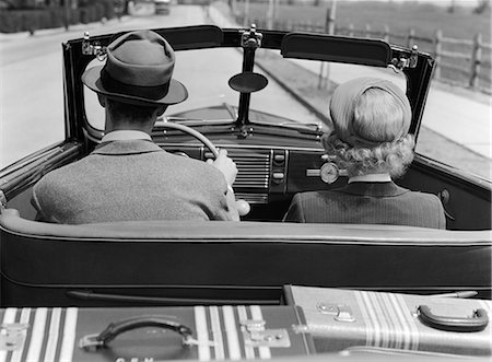 strange b&w - 1930s 1940s REAR VIEW COUPLE DRIVING TOGETHER IN CONVERTIBLE  LUGGAGE IN BACK SEAT Stock Photo - Rights-Managed, Code: 846-06112149