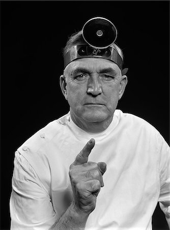 simsearch:846-03163297,k - 1950s PORTRAIT MAN DOCTOR WEARING EXAMINATION MIRROR POINTING SHAKING FINGER GIVING STERN WARNING LOOKING AT CAMERA Stock Photo - Rights-Managed, Code: 846-06112155