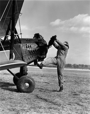 simsearch:846-09085303,k - 1920s MALE PILOT TRYING TO TURN PLANE'S PROPELLER BY HAND Stock Photo - Rights-Managed, Code: 846-06112248