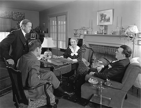 simsearch:846-02797224,k - 1930s 1940s TWO SALESMEN MAKING SALES PRESENTATION TO OLDER COUPLE HUSBAND AND WIFE SITTING IN LIVING ROOM Stock Photo - Rights-Managed, Code: 846-06112409