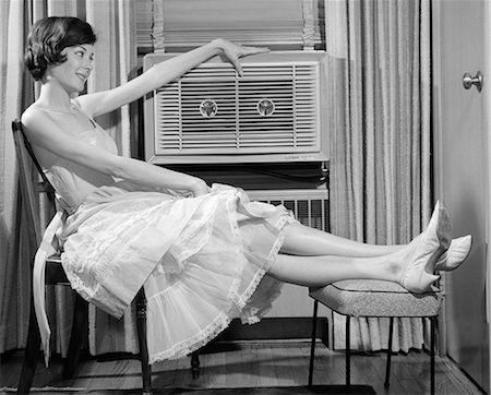 prop - 1960s SIDE VIEW OF WOMAN IN GINGHAM DRESS PROPPING LEGS UP ON STOOL PUTTING HAND ON TOP OF AIR CONDITIONER Stock Photo - Rights-Managed, Code: 846-06112418