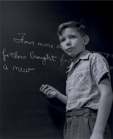 portrait black and white - 1940s GRADE SCHOOL BOY AT CHALKBOARD WRITING OUT GETTYSBURG ADDRESS Stock Photo - Rights-Managed, Code: 846-06112422