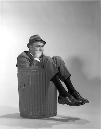 simsearch:846-02796922,k - 1960s BUSINESSMAN IN SUIT AND HAT SITTING IN TRASHCAN Stock Photo - Rights-Managed, Code: 846-06112450