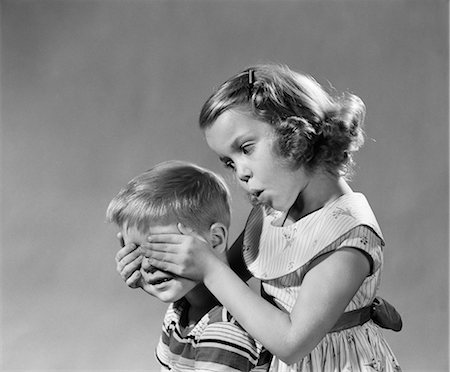 disabled children - 1950s 1960s GUESS WHO GIRL HOLDS HER HANDS OVER BOYS EYES BLIND GAME TEASING PLAYING BOY GIRLS Stock Photo - Rights-Managed, Code: 846-07200085