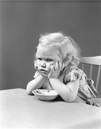 retro vintage people - 1940s UNHAPPY GRUMPY LITTLE BLONDE GIRL SITTING IN HIGHCHAIR REFUSING TO EAT Stock Photo - Rights-Managed, Code: 846-07200081