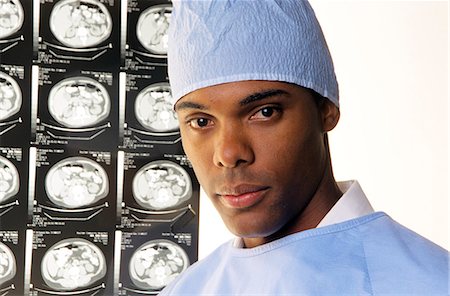 simsearch:846-09085295,k - 2000s PORTRAIT OF AFRICAN AMERICAN DOCTOR WEARING SCRUBS LOOKING AT CAMERA WITH BODY SCANS IN BACKGROUND Stock Photo - Rights-Managed, Code: 846-07760720