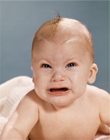 1960s CRYING BABY WITH ANGRY MEAN FACIAL EXPRESSION LOOKING AT CAMERA Stock Photo - Rights-Managed, Code: 846-08030384