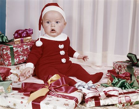 simsearch:846-09013030,k - 1960s AMAZED BABY IN SANTA SUIT SITTING AMONG WRAPPED PRESENTS Stock Photo - Rights-Managed, Code: 846-08030406