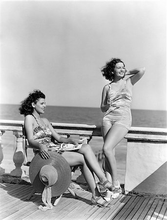 simsearch:846-02796192,k - 1930s 1940s TWO WOMEN SITTING ON HOTEL DECK BEACH SIDE IN ONE PIECE BATHING SUIT FASHION FLORIDA USA Photographie de stock - Rights-Managed, Code: 846-08140106