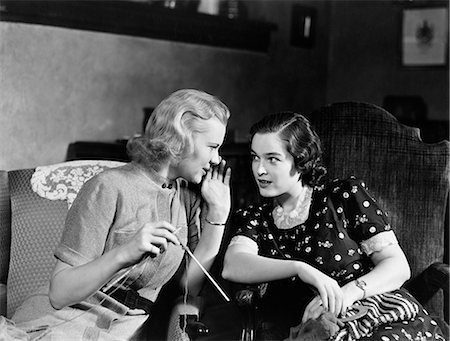 1930s TWO WOMEN SITTING IN CHAIRS IN PRIVATE CONVERSATION WOMAN HAS HAND TO SIDE OF MOUTH TO TELL SECRET Stock Photo - Rights-Managed, Code: 846-08140108